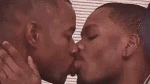 two men kissing each other on the cheek