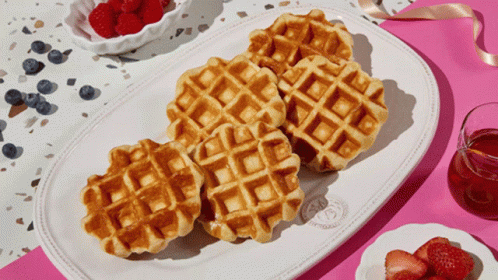 a plate with waffles covered in blue candy