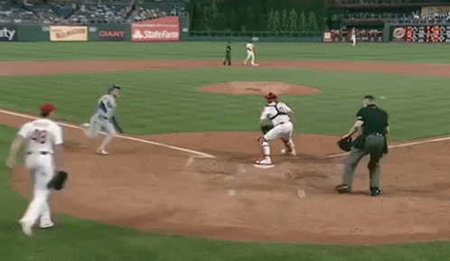 some baseball players are playing baseball on a field