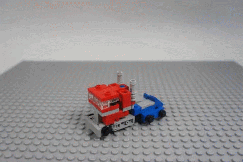 a toy is on a grey surface with a lego truck