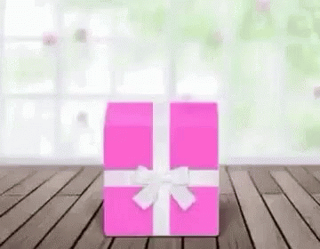 the pink gift box is next to a green background