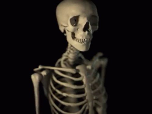 a skeletal skeleton holds up a cell phone