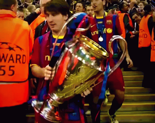 young men walking down the stairs holding trophies