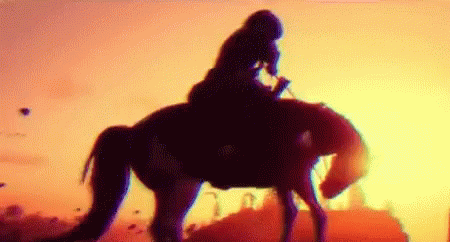 a blurry po of a woman on top of a horse