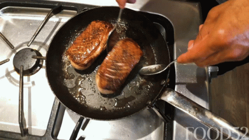 two uncooked hamburgers in a frying pan