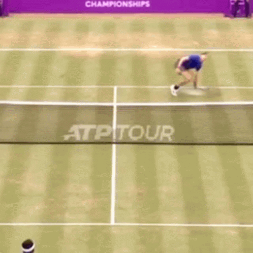 a tennis player holding a racquet on top of a court