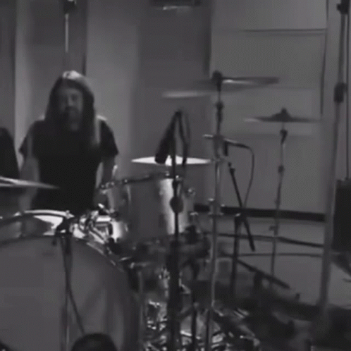 some musicians are playing drums in black and white