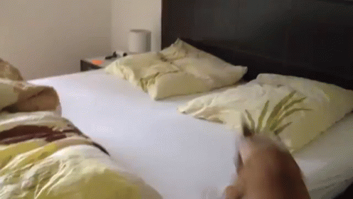 a person is standing in the bed with his foot on the edge