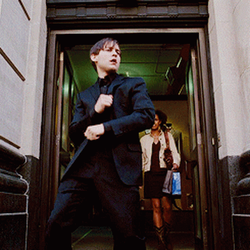 a man in suit running through an elevator