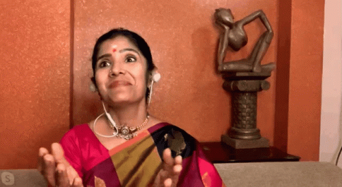 woman in a sari talking into a microphone