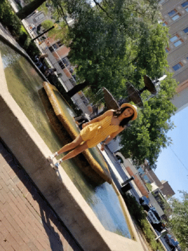 a water fountain in a public plaza near the river