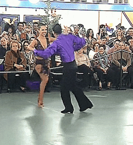 two people are dancing in front of an audience