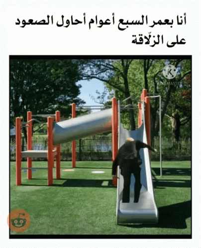 the girl is playing on the slide in the park