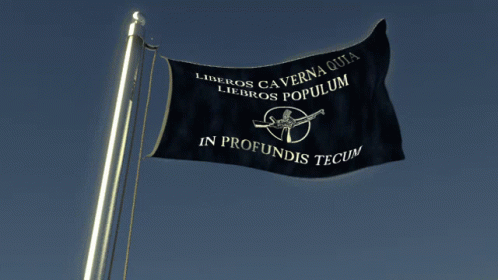 a black flag on top of the flag pole
