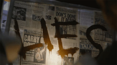 the word dirty in black spray paint with a news paper background