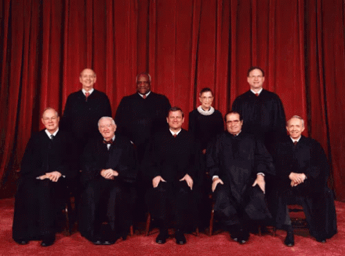 an image of an old supreme court in front of blue curtain