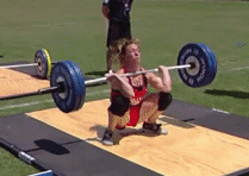 man doing a squat in a competition