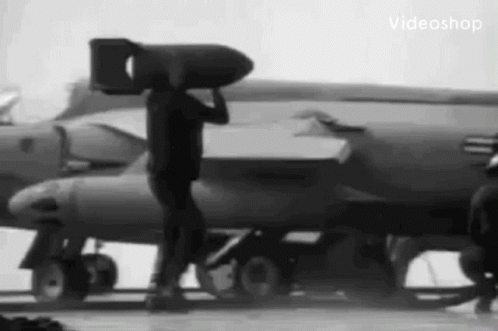a man standing next to an airplane on top of a tarmac