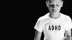 the person is standing in front of the camera and wearing a shirt with adhd on it