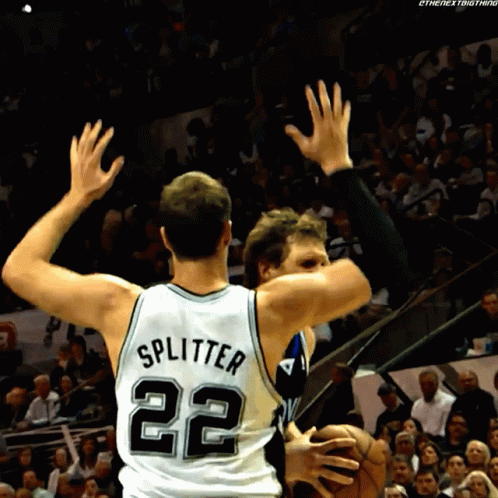 two basketball players in white and black uniforms