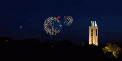 fireworks are being performed on top of a tall building