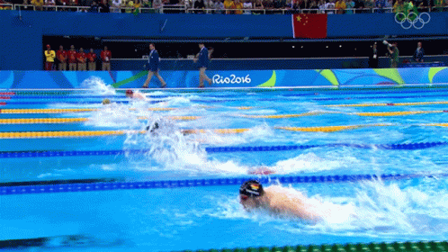 an olympic swimming event in the middle of a large pool