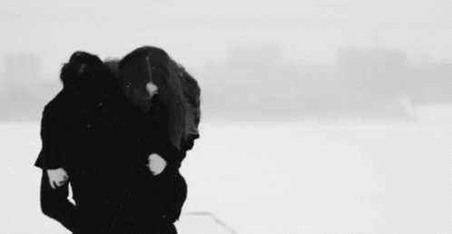 a couple of people standing next to each other in the snow