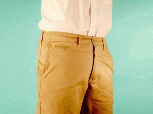 a close - up of a man's pants against a green background