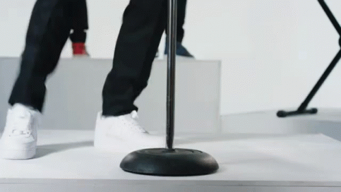 two feet are standing on black metal poles