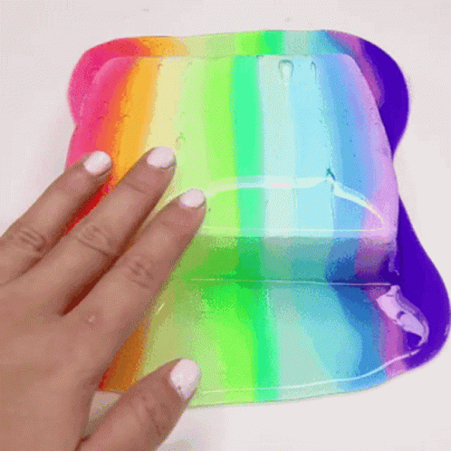 a hand touching a clear, rainbow - colored plastic case