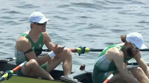 two men in the middle of rowing in a lake
