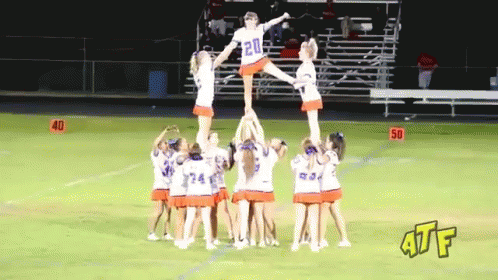 a large group of young cheerleaders all standing in a circle