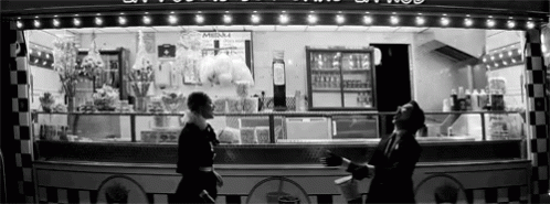 a black and white po shows people outside a restaurant