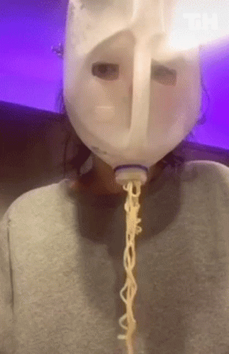 a person is wearing a mask and chain attached to the hood