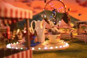 the table is set up in front of a carnival rides theme