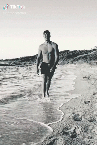 a man walks into the ocean, and smiles