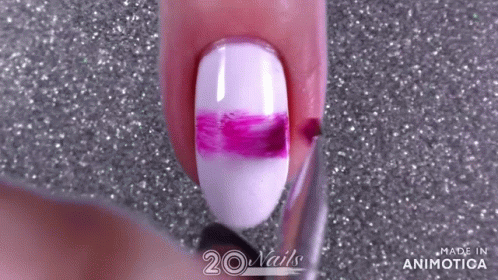 a woman with purple and white nails is holding a brush