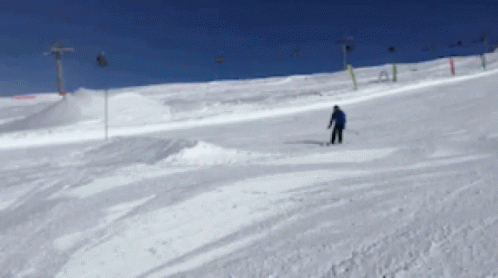 a person on skis rides along a snowy hill