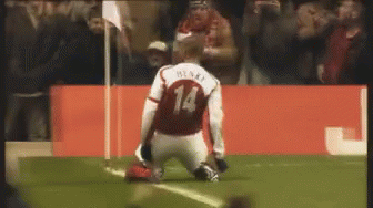 a soccer player is kneeling down at the end of a game