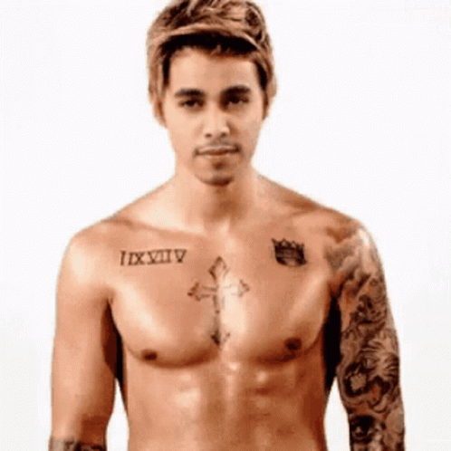 a tattooed man with a tattoo is standing in his underwear