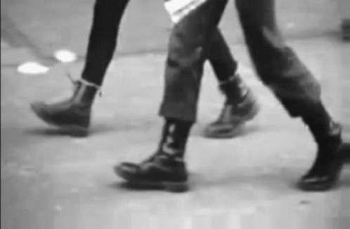 black and white image of feet walking on street