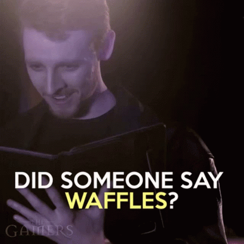 a man holding a book with the words did someone say waffles?