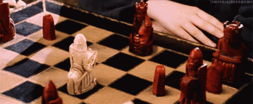 a man is playing chess on the checkered board