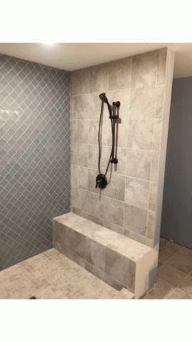 a tiled bathroom with a shower head