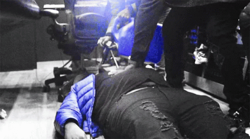 the man lies on the floor near the machine