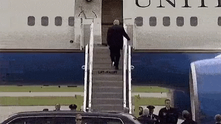 a man walking down a stair outside an airplane