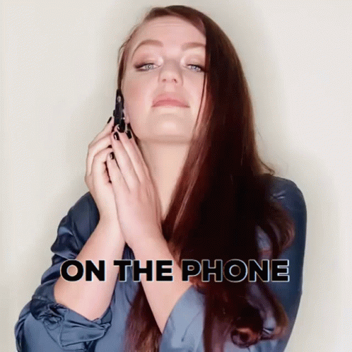 woman holding up phone to the side with the text on the phone