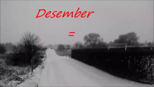the cover for december is a snowy road with a train crossing