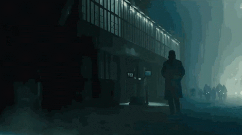 a person walking in the dark on the street