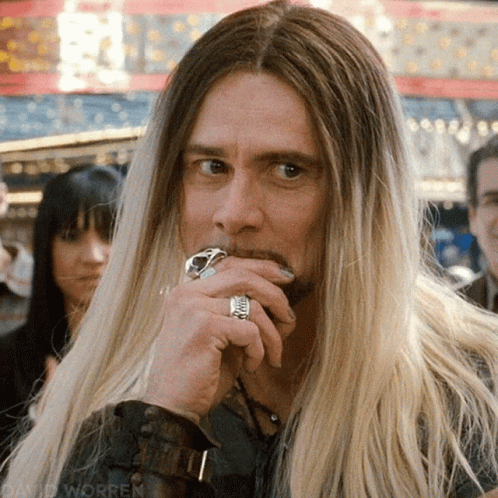 long hair guy with ring and piercing in public